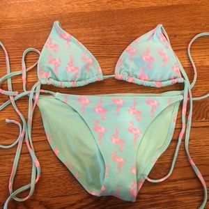 This is a teal flamingo bathing suit